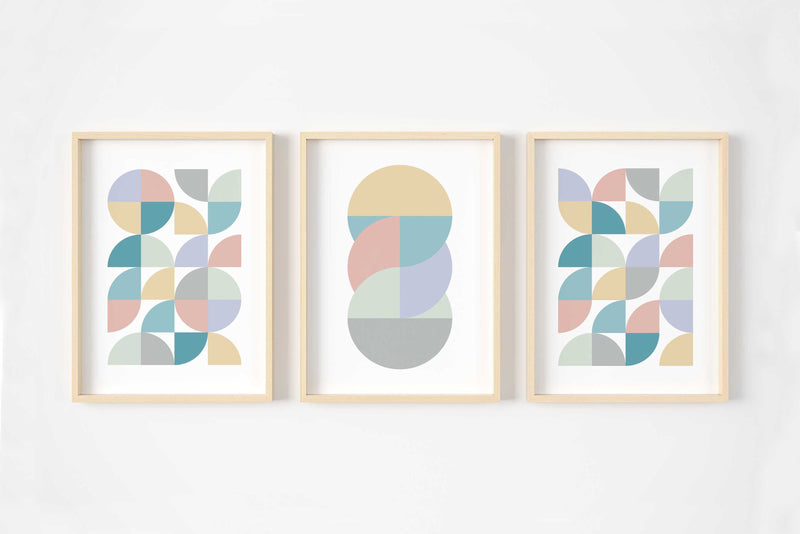 A set of three pastel abstract wall art prints in pinks, blues, yellows and greens